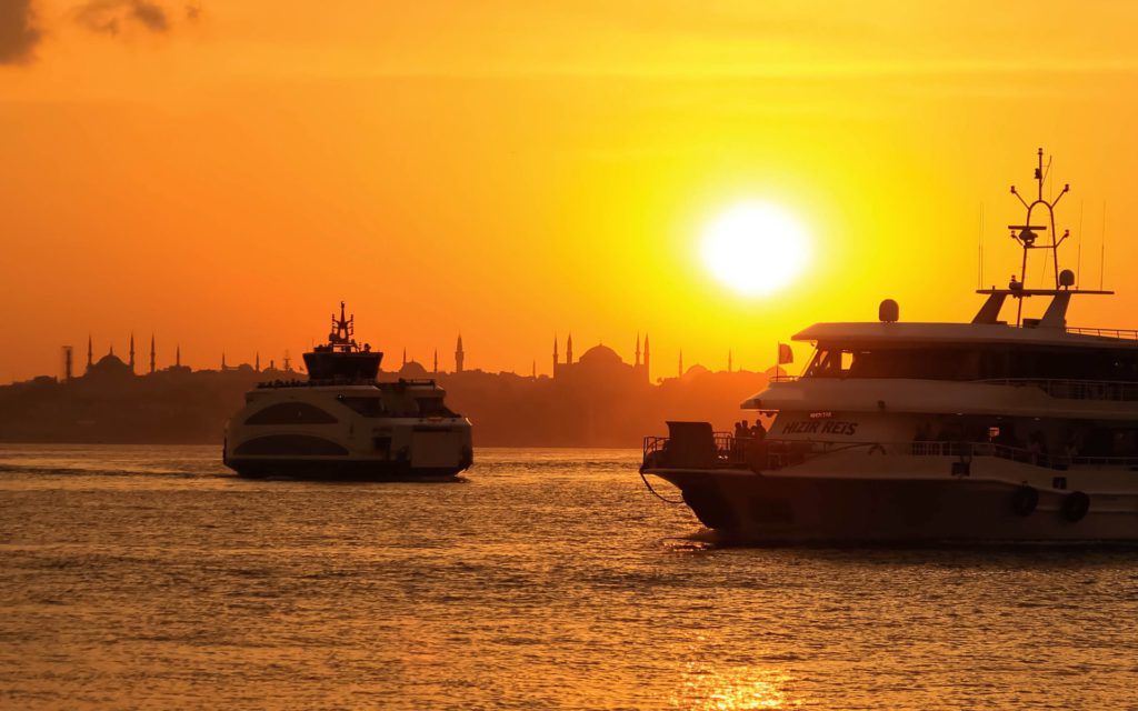 White and black boat at sunset