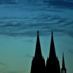 Silhouette of tower under cloudy sky