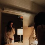 woman crying in front of mirror