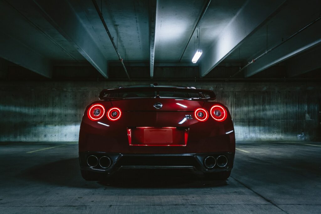 Tail lights of a sporty red car driving away